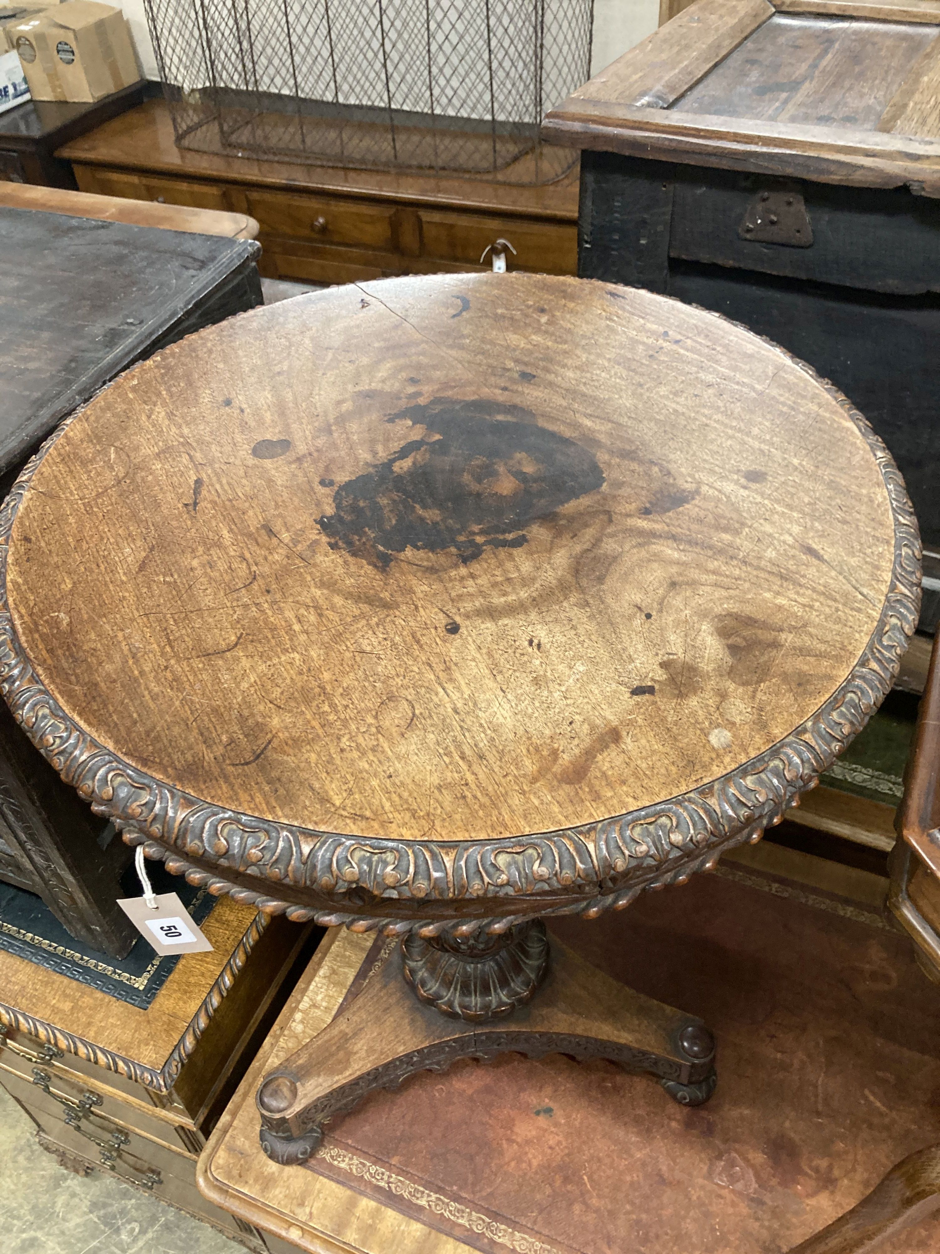 A 19th century Anglo / Indian carved padouk circular tilt top table, 60cm diameter, height 74cm